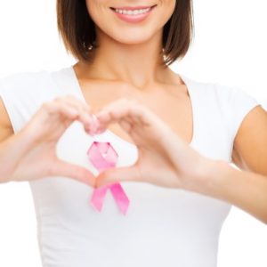 Woman-Making-Heart-Shape-With-Breast-Cancer-Ribbon