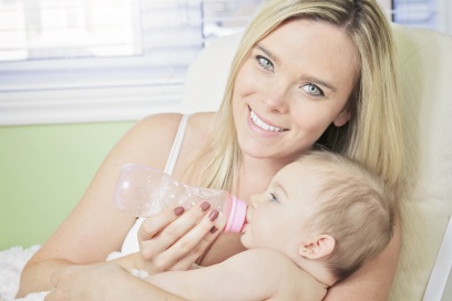 Mother-Feeding-Child-Milk-From-Breast-Pump