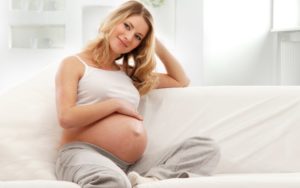 Pregnant-Woman-Sitting-On-Couch
