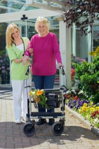 Medical-Supplies-Fitter-Helping-Woman-With-Walker