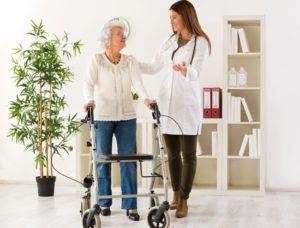 Medical-Supply-Employee-Helping-Woman-With-Walker