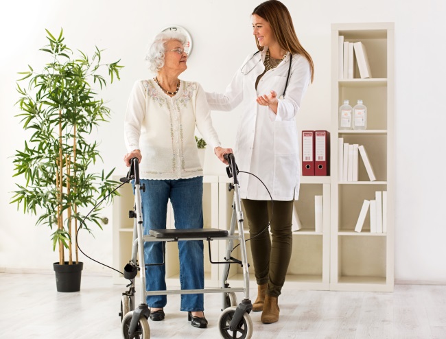 Medical-Supply-Employee-Helping-Woman-With-Walker