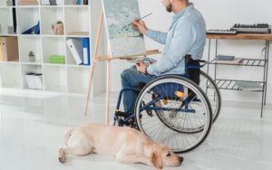 Man-Painting-In-Wheelchair-With-Service-Dog