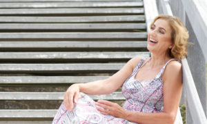 Woman-Sitting-On-Steps-Smiling