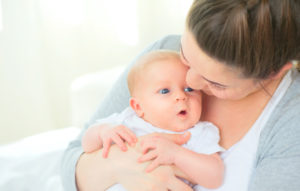 Mother-Holding-Baby-After-Using-Breast-Pump