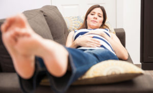 Woman-On-Couch-With-Swollen-Feet