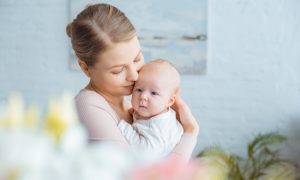 Mother-Holding-Newborn-Child